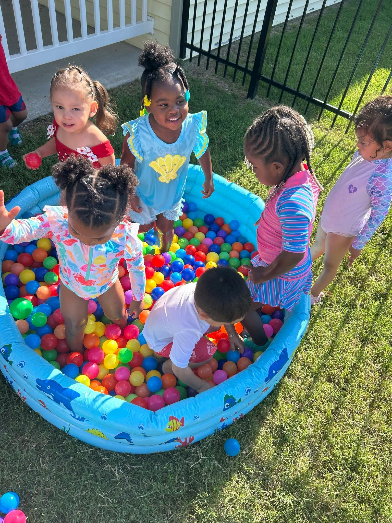 Children playing in an inflatable ball pit outdoors