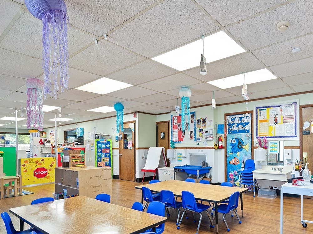Colorful classroom with tables, chairs, and jellyfish decorations