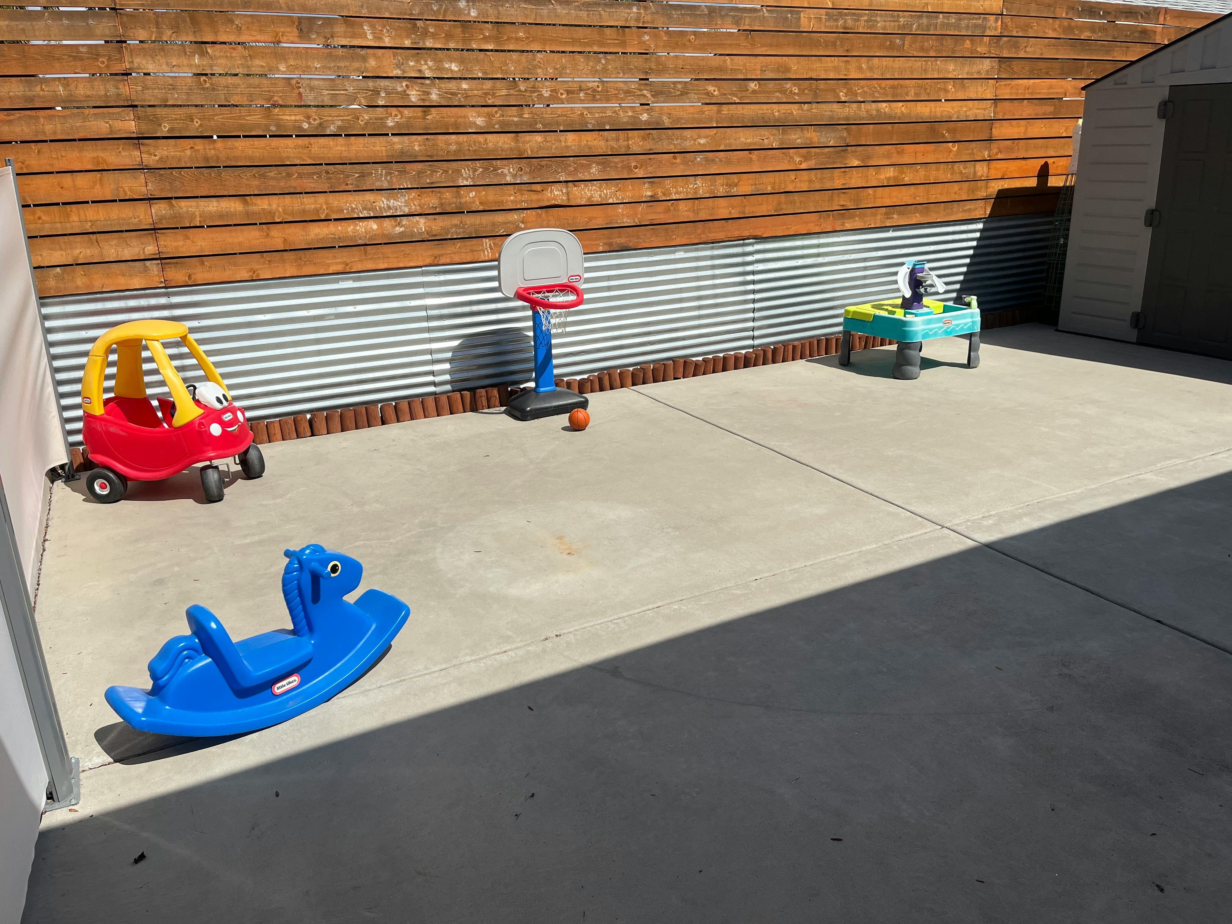 Children's toys on a concrete patio