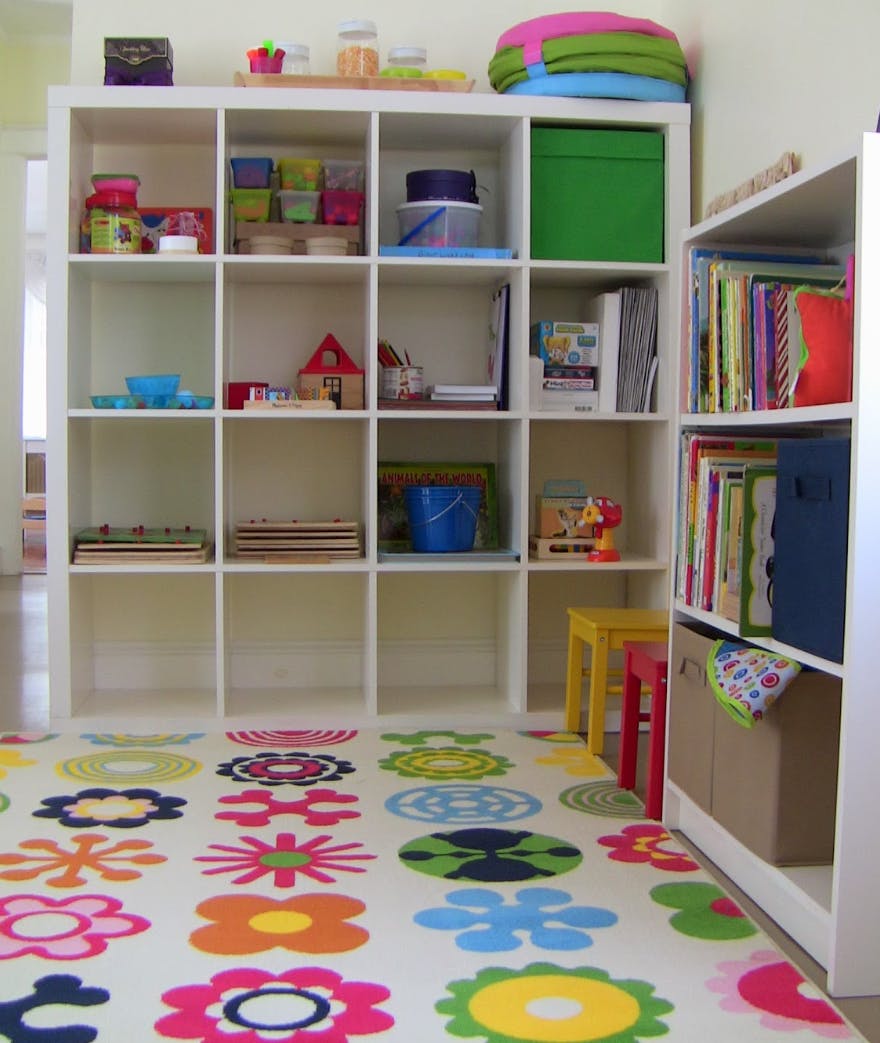 Shelving units with various items and a colorful floral rug