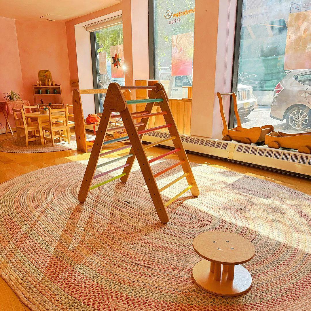 Wooden climbing frame with colorful rungs on a rug in a room