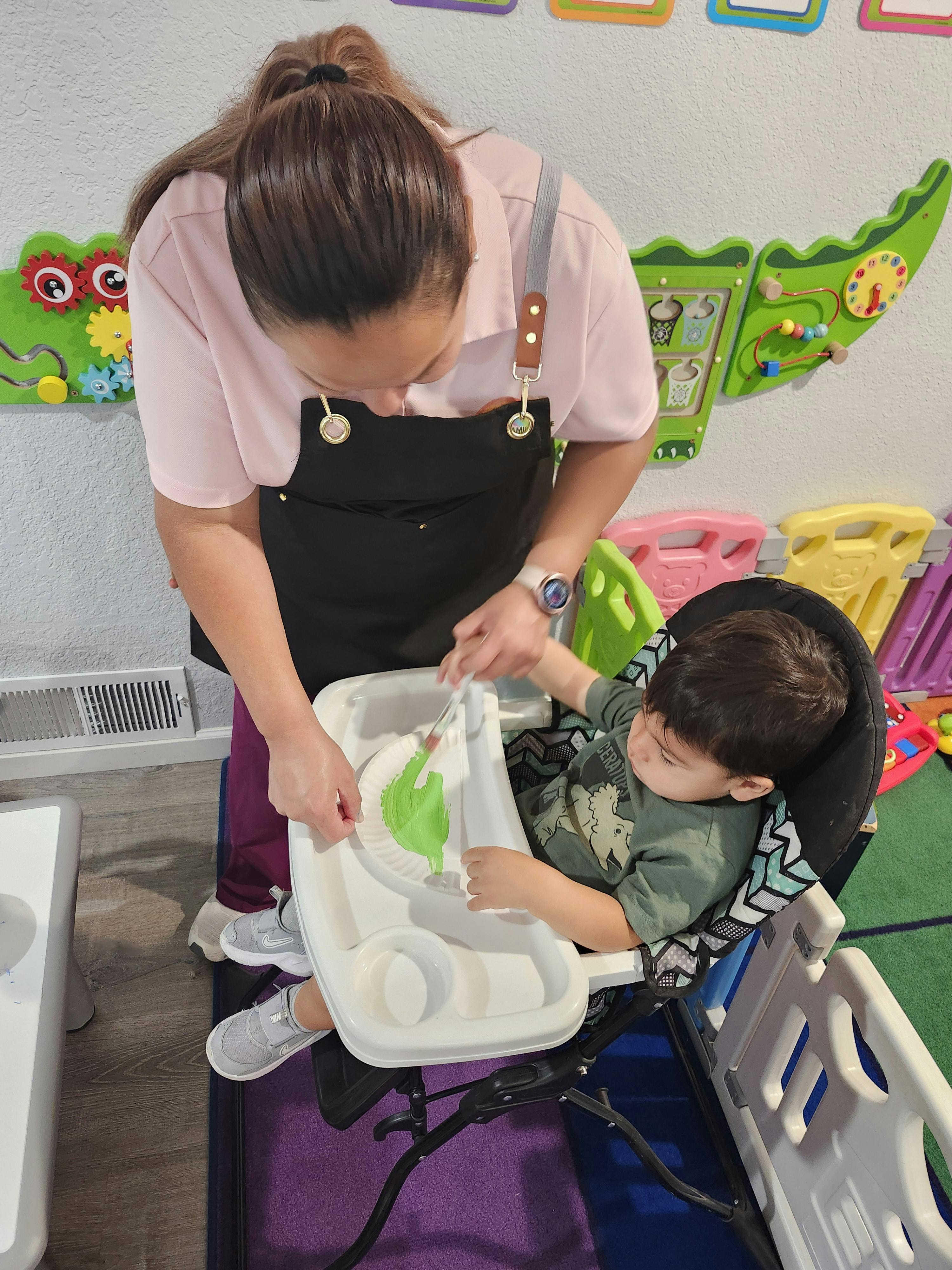Person helping a child in a high chair