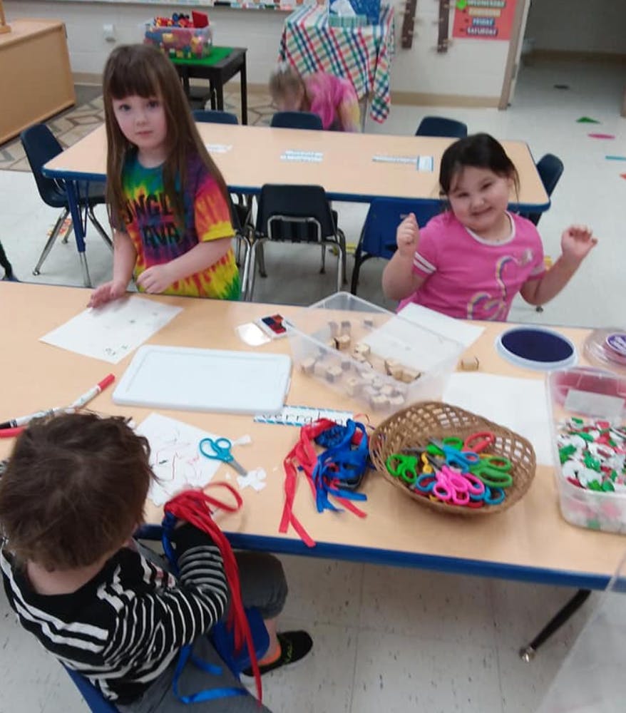 Children at a table with craft supplies