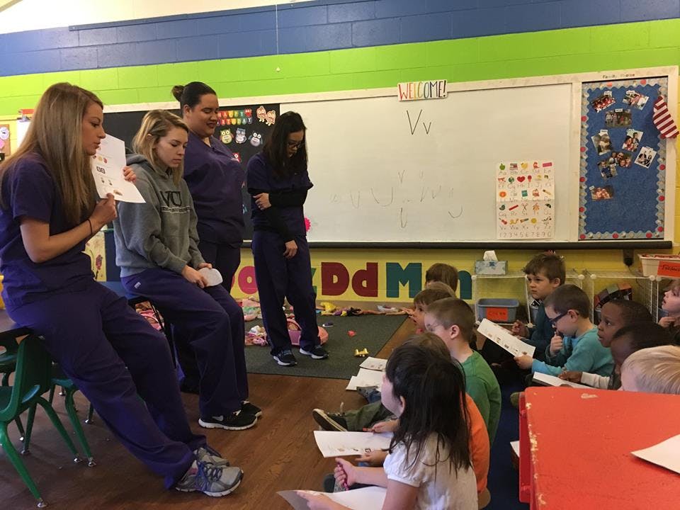 Adults and children in a classroom