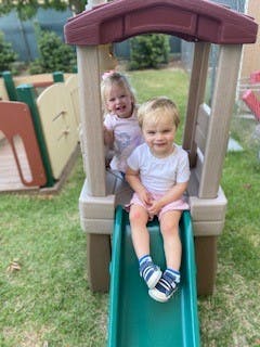 Two children on a playground slide