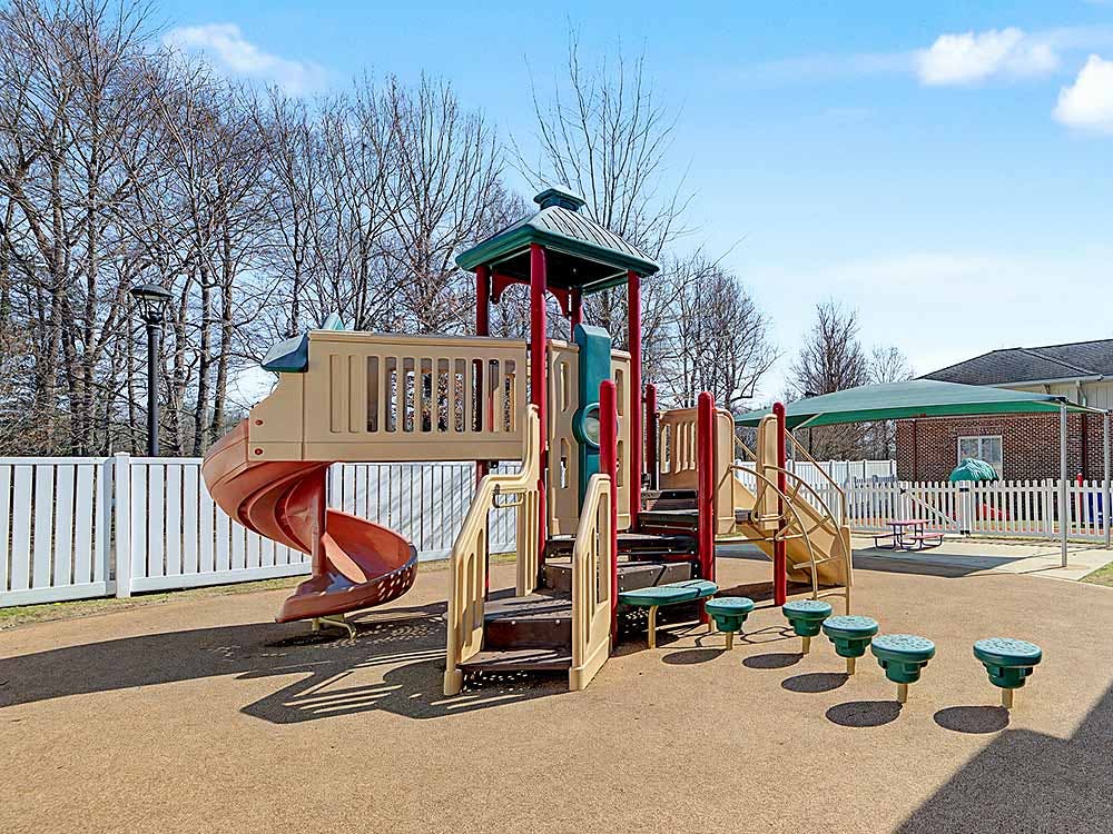 Playground with slides, steps, and balance steps on rubber surfacing