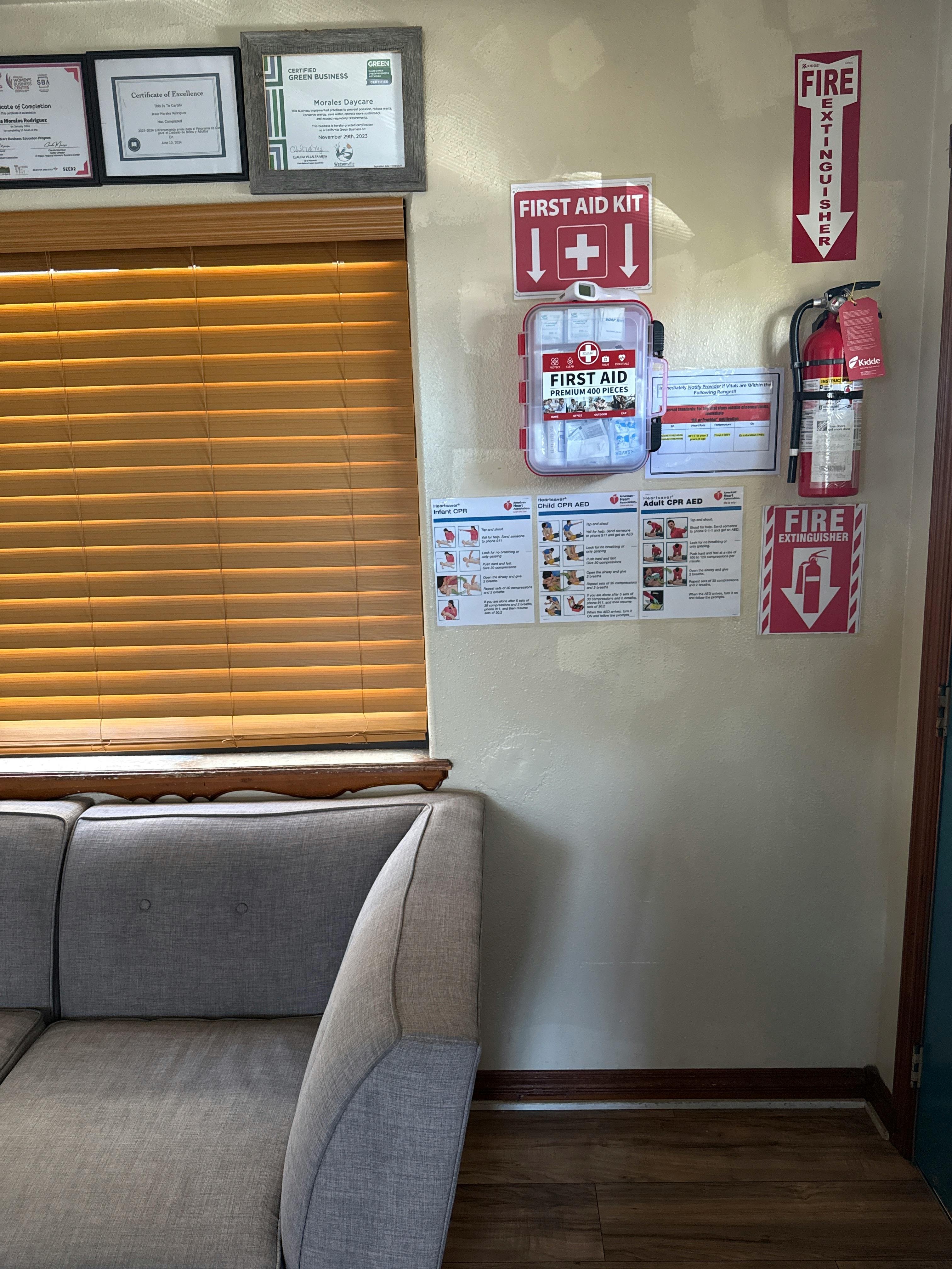 Fire extinguisher, first aid kit, and emergency instructions on a wall