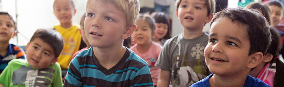 Group of children looking up in a classroom