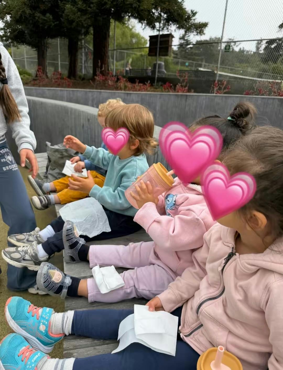 Group of children sitting on a bench outdoors