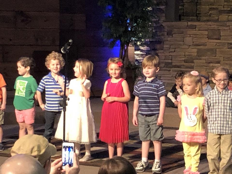 Group of children standing on a stage