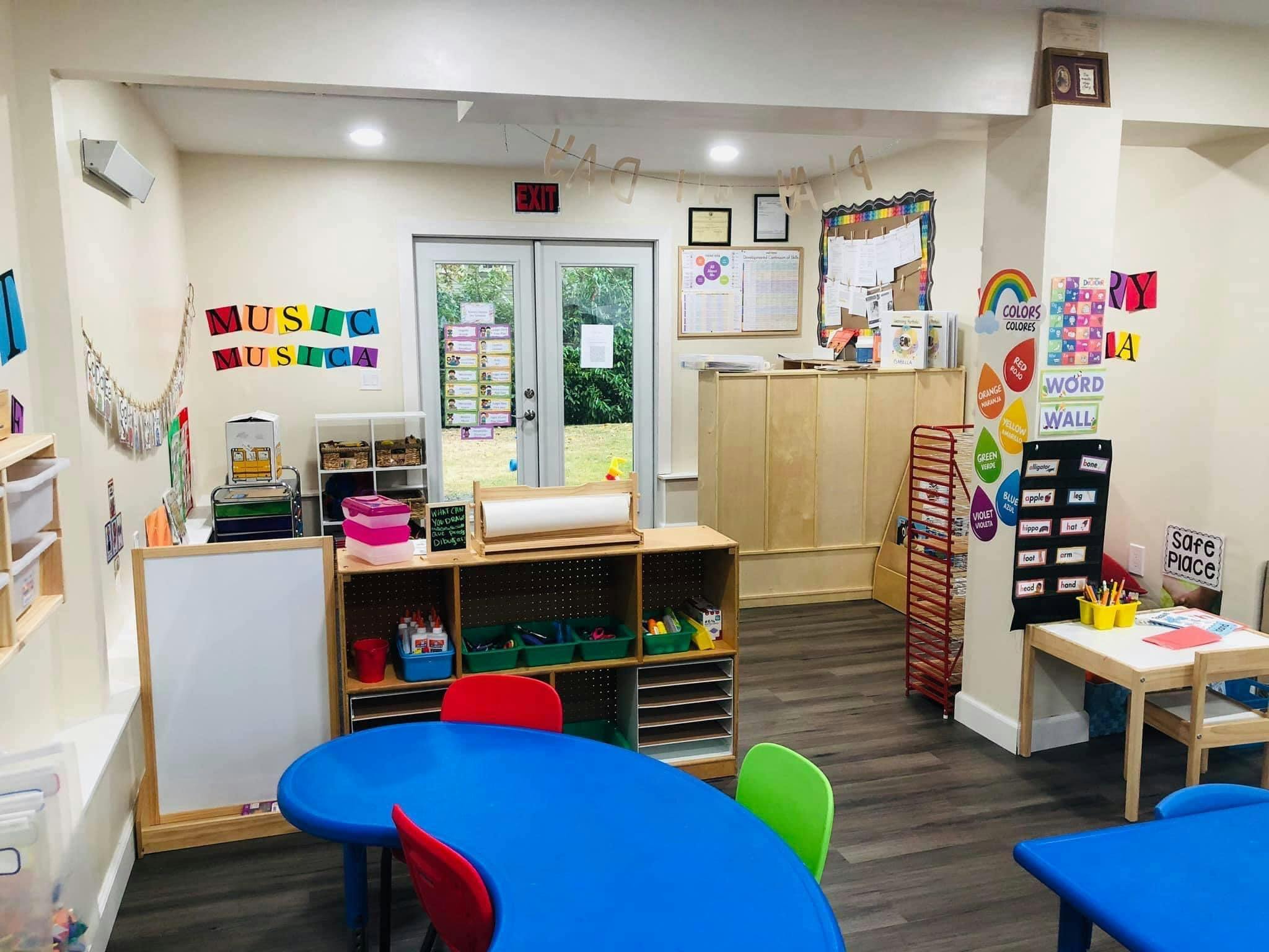 Classroom with colorful tables and chairs, storage shelves, and decorations