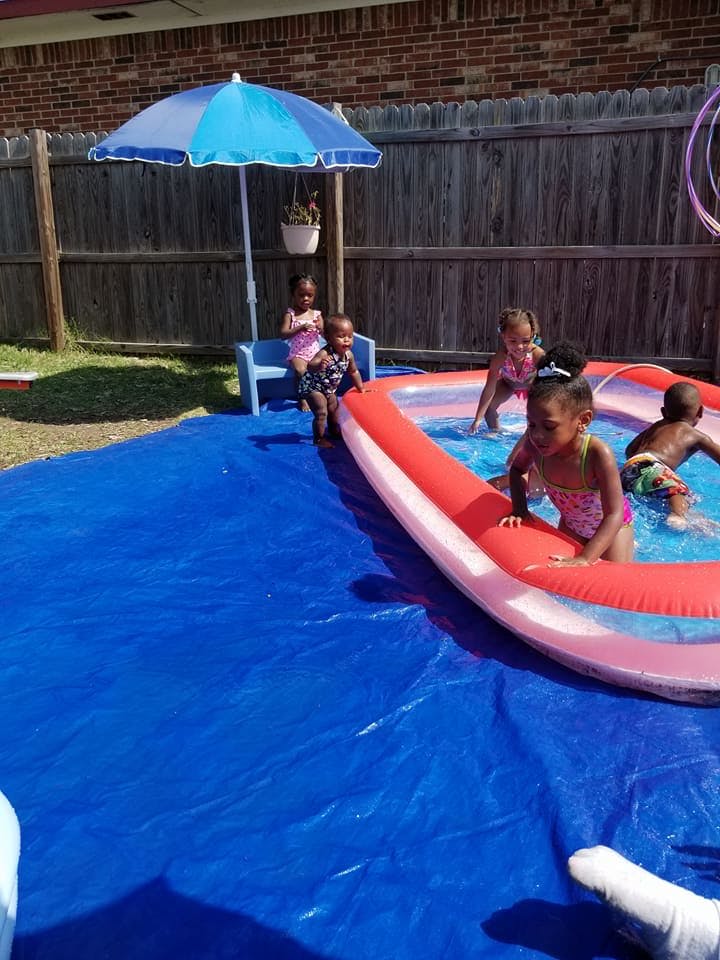 Children playing in an inflatable pool outdoors