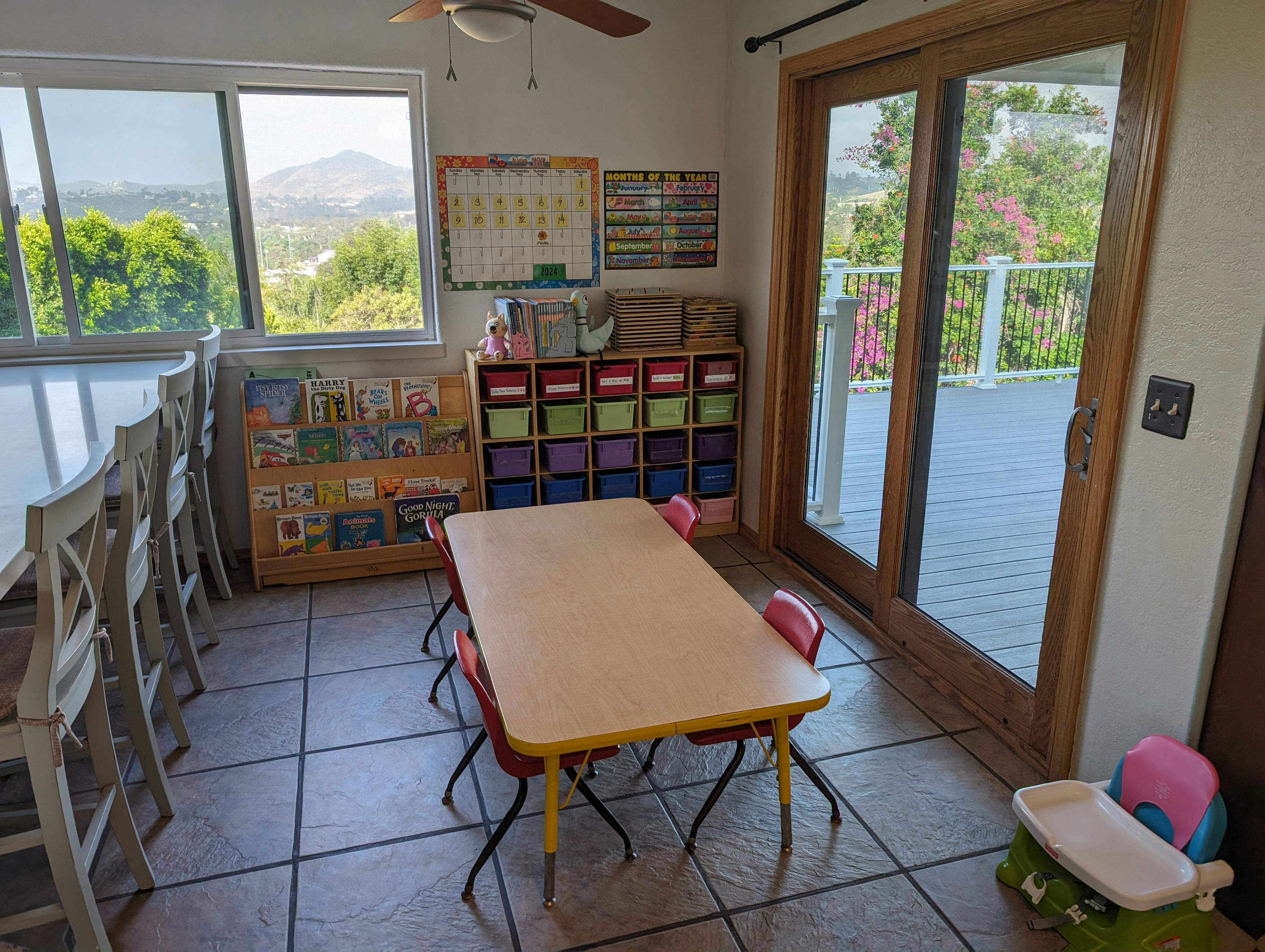 Classroom with small tables and chairs, storage, and large windows