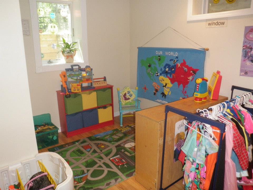 Children's play area with toys, storage, and a world map on the wall