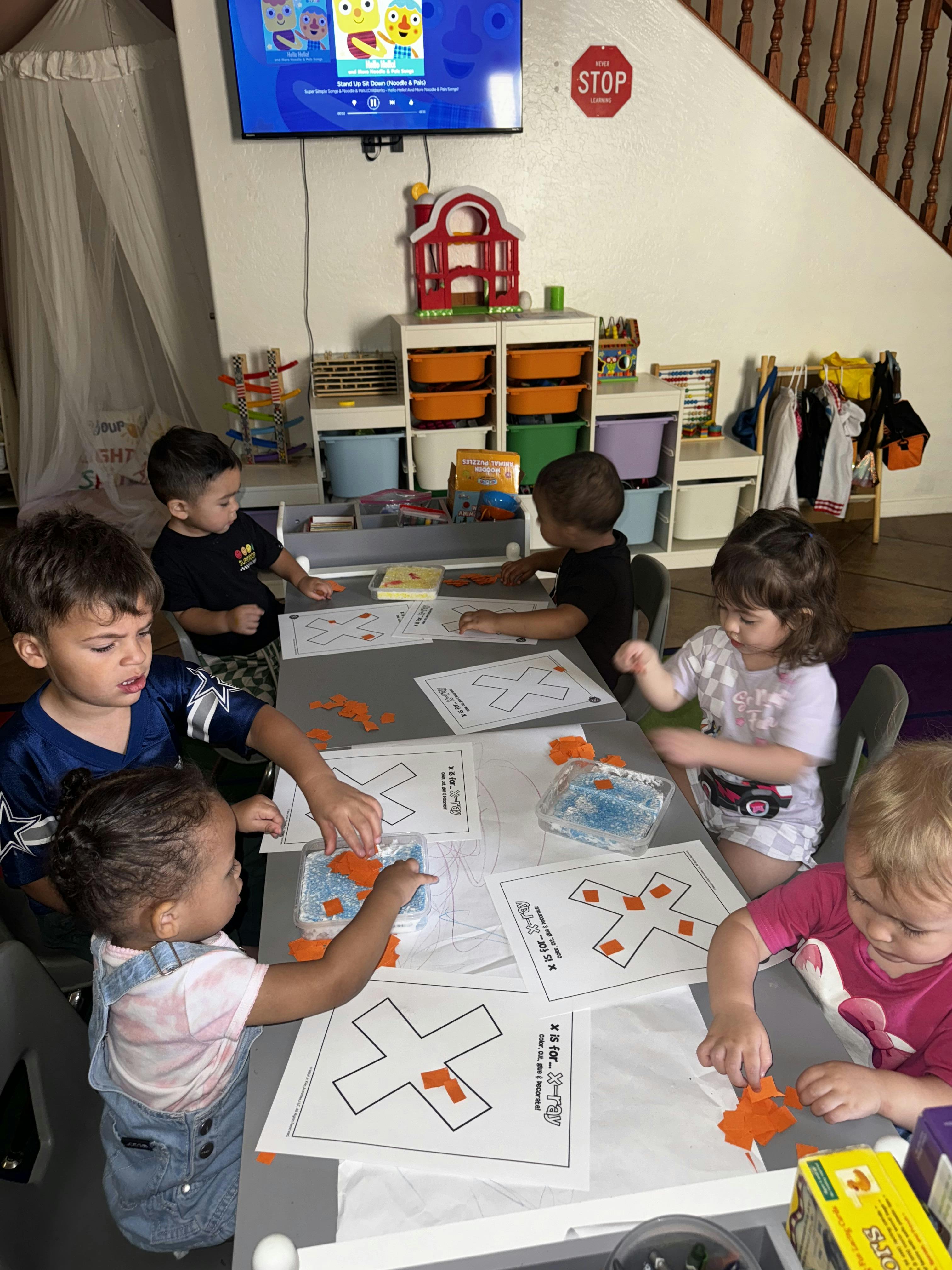 Children doing an X-is-for-X-ray craft in a classroom