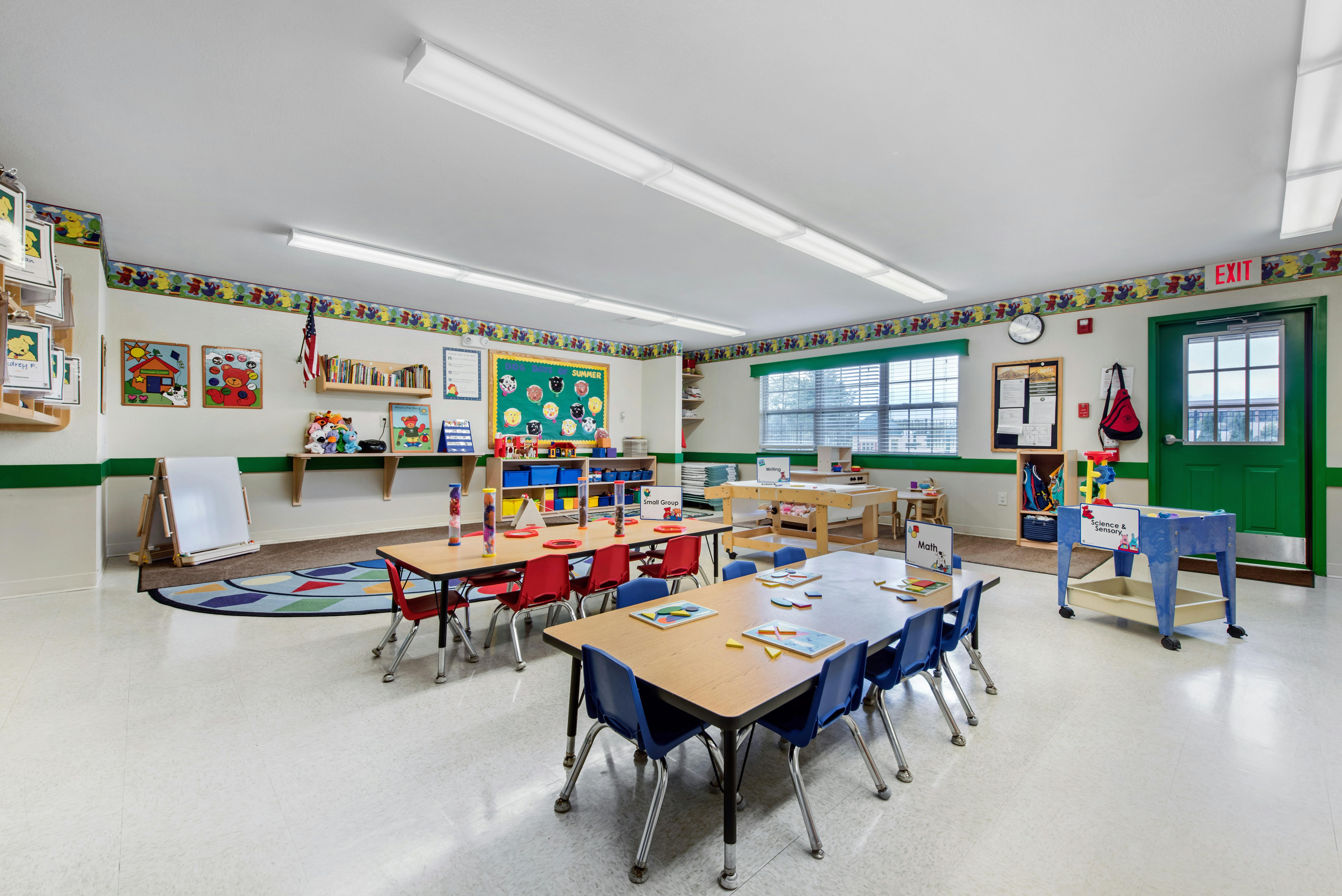 Classroom with child-sized tables and chairs, learning materials