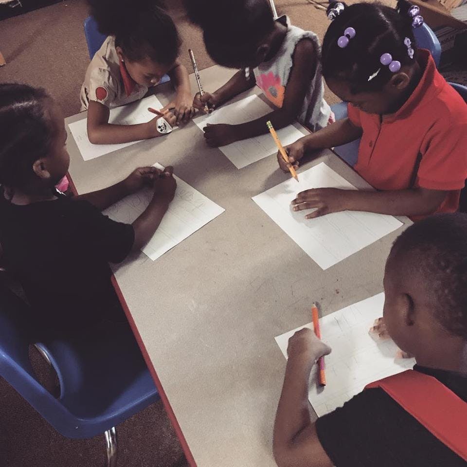 Children drawing at a table