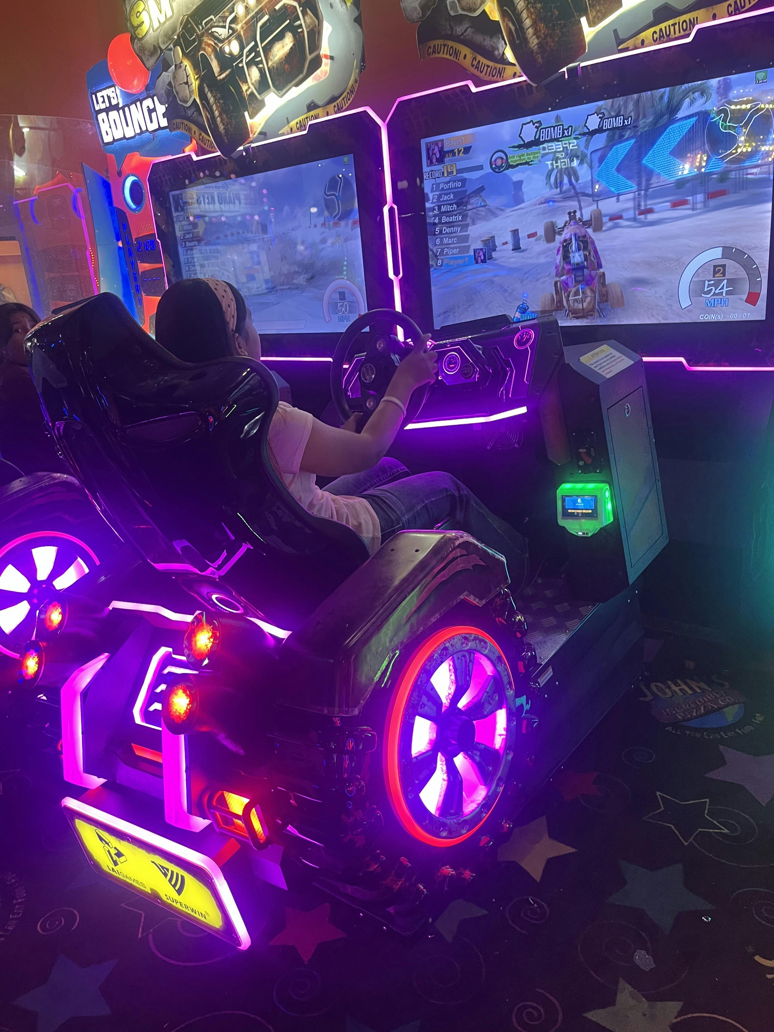 Person playing a racing arcade game