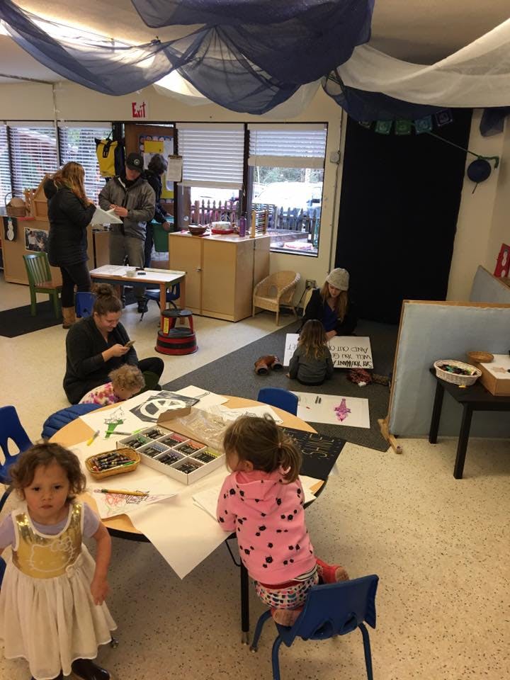 People and children in a classroom