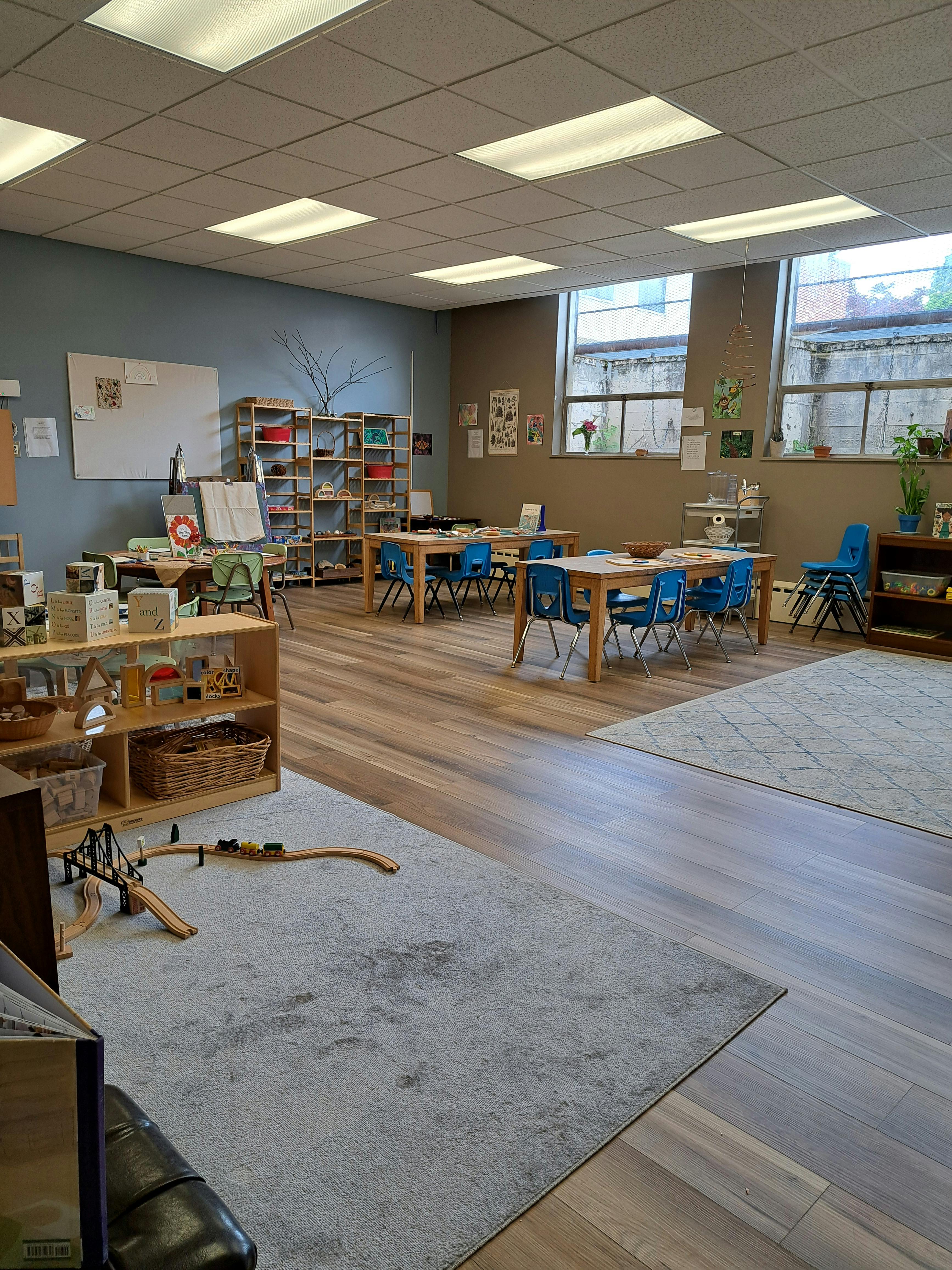 Classroom interior with tables chairs and shelving for toys and learning