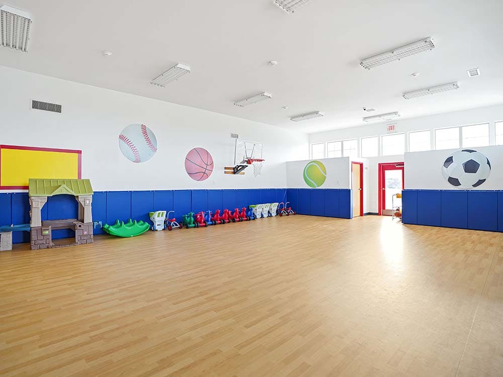 Empty children's playroom with sports ball decals and toys