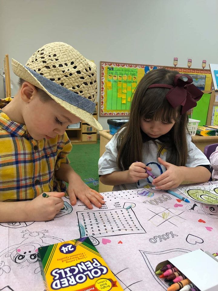 Two children coloring at a table
