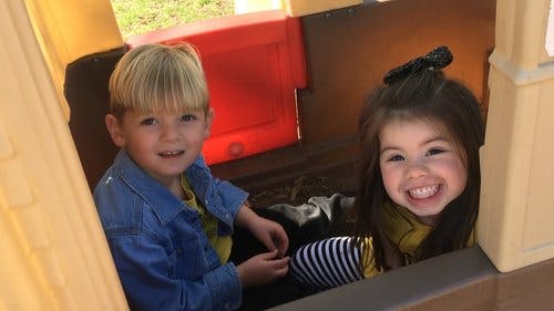 Two children in a playhouse