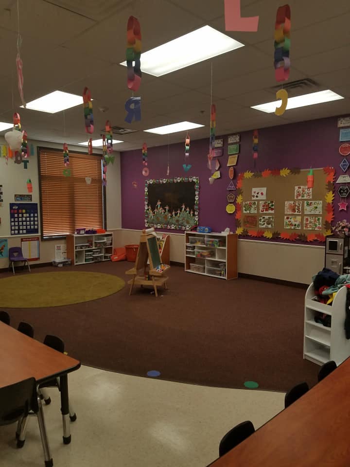Classroom with purple walls, bulletin boards, and hanging decorations