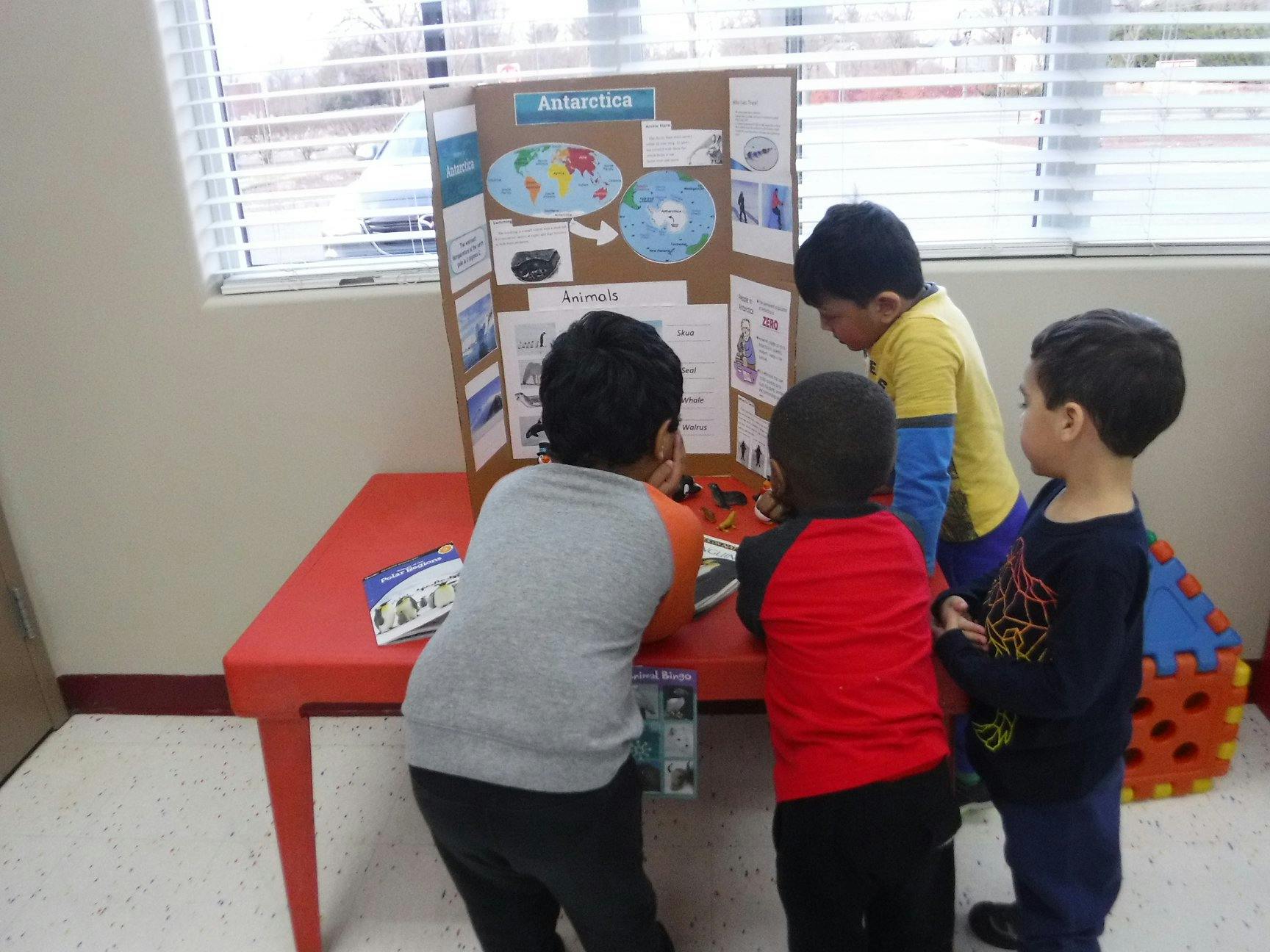 Children looking at a science project display board