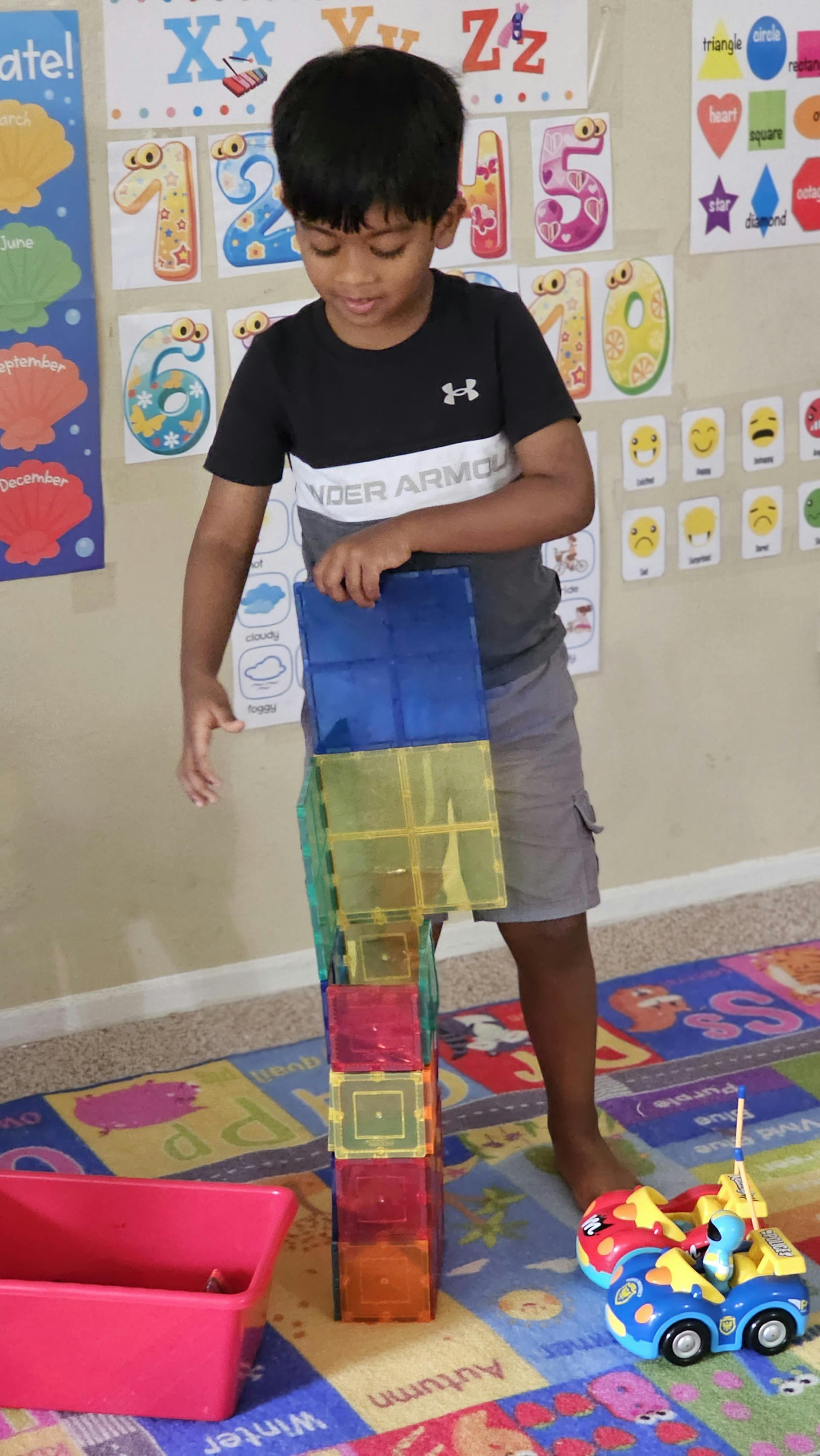 Child playing with colorful magnetic building blocks