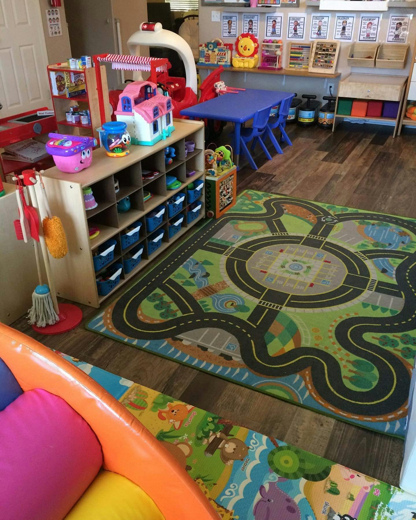 Playroom with toy storage, play rug, and small table with chairs