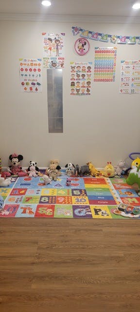 Playroom with a colorful alphabet mat and stuffed animals