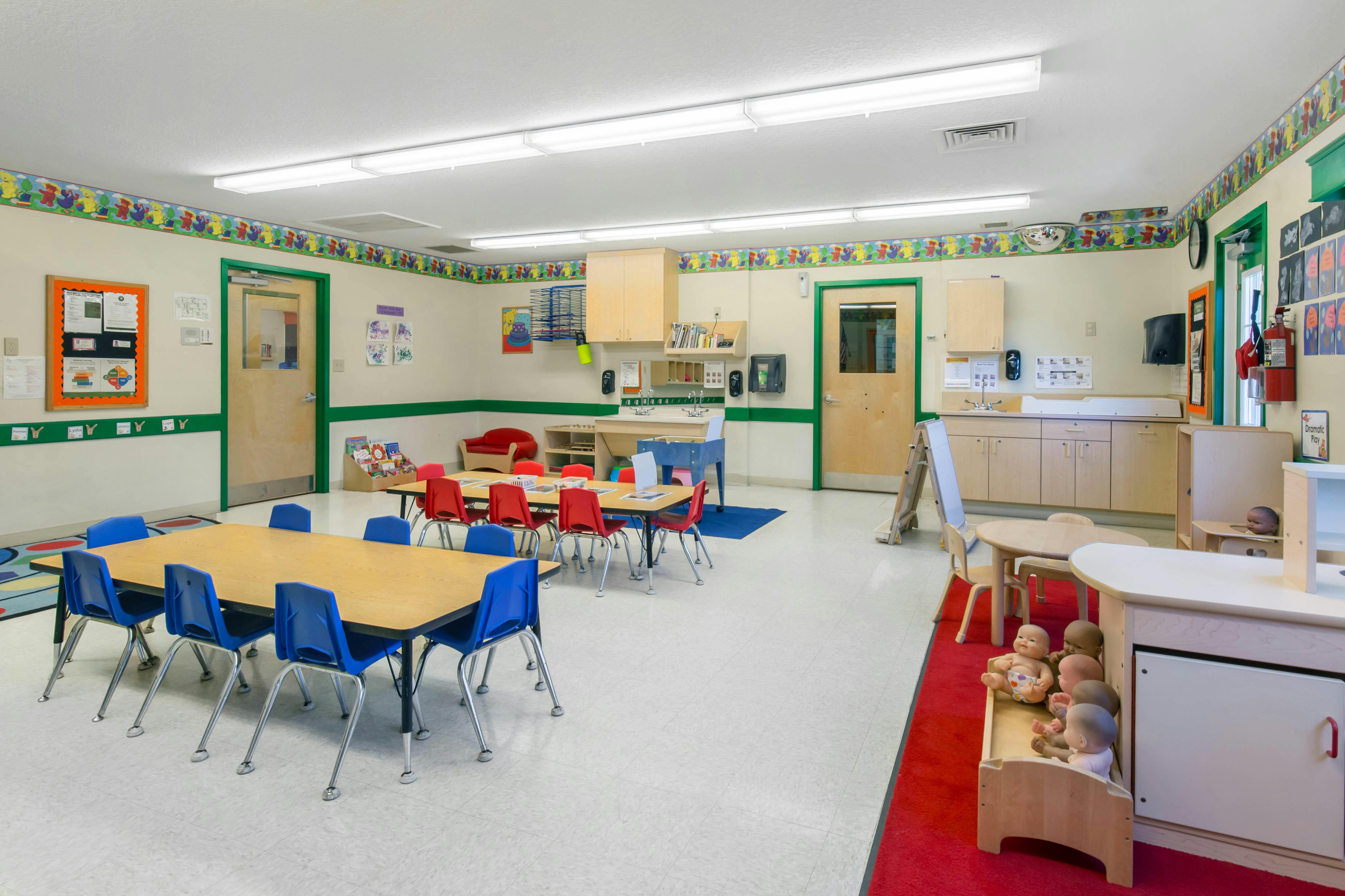 Empty classroom with small tables and chairs
