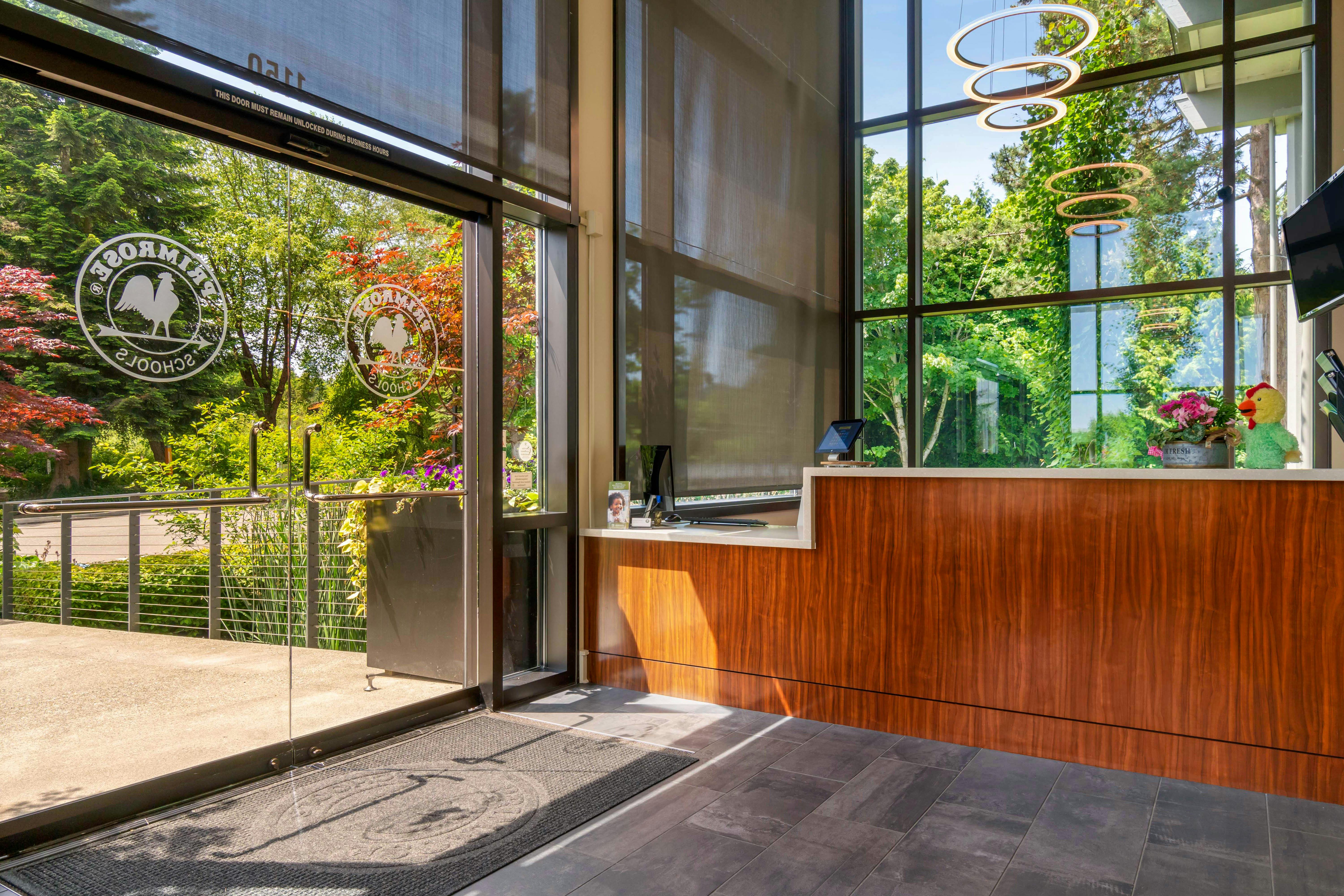 An empty reception desk inside a modern building with large glass windows