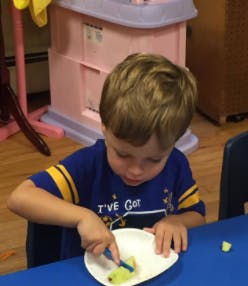 Child cutting food on a plate