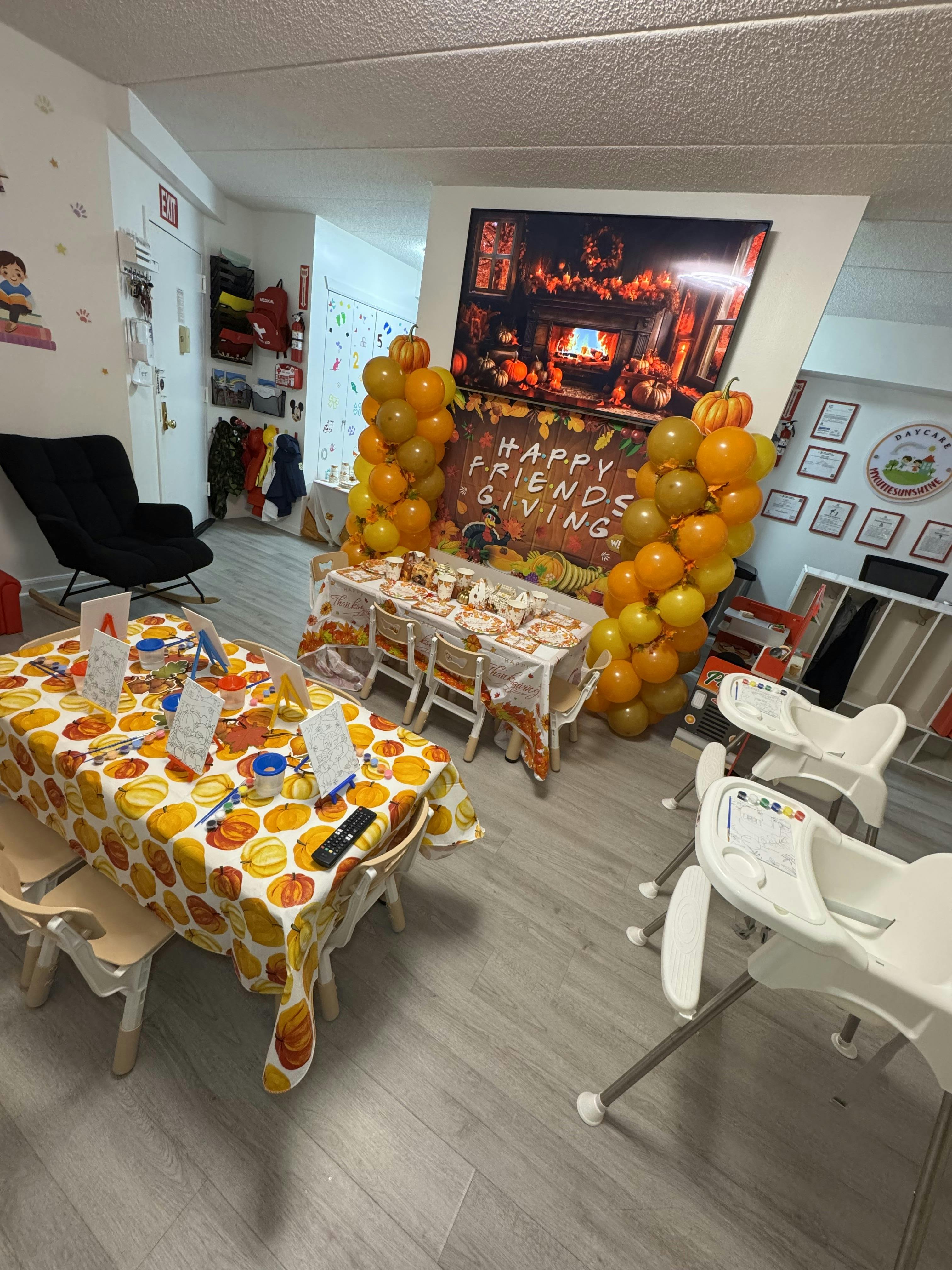 Room decorated with tables, chairs, and balloons for a celebration