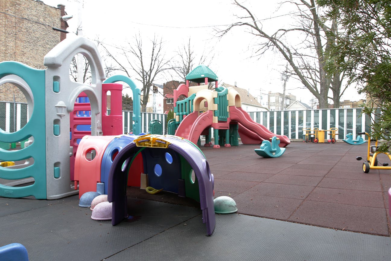 Empty outdoor playground with colorful climbing structures and slides