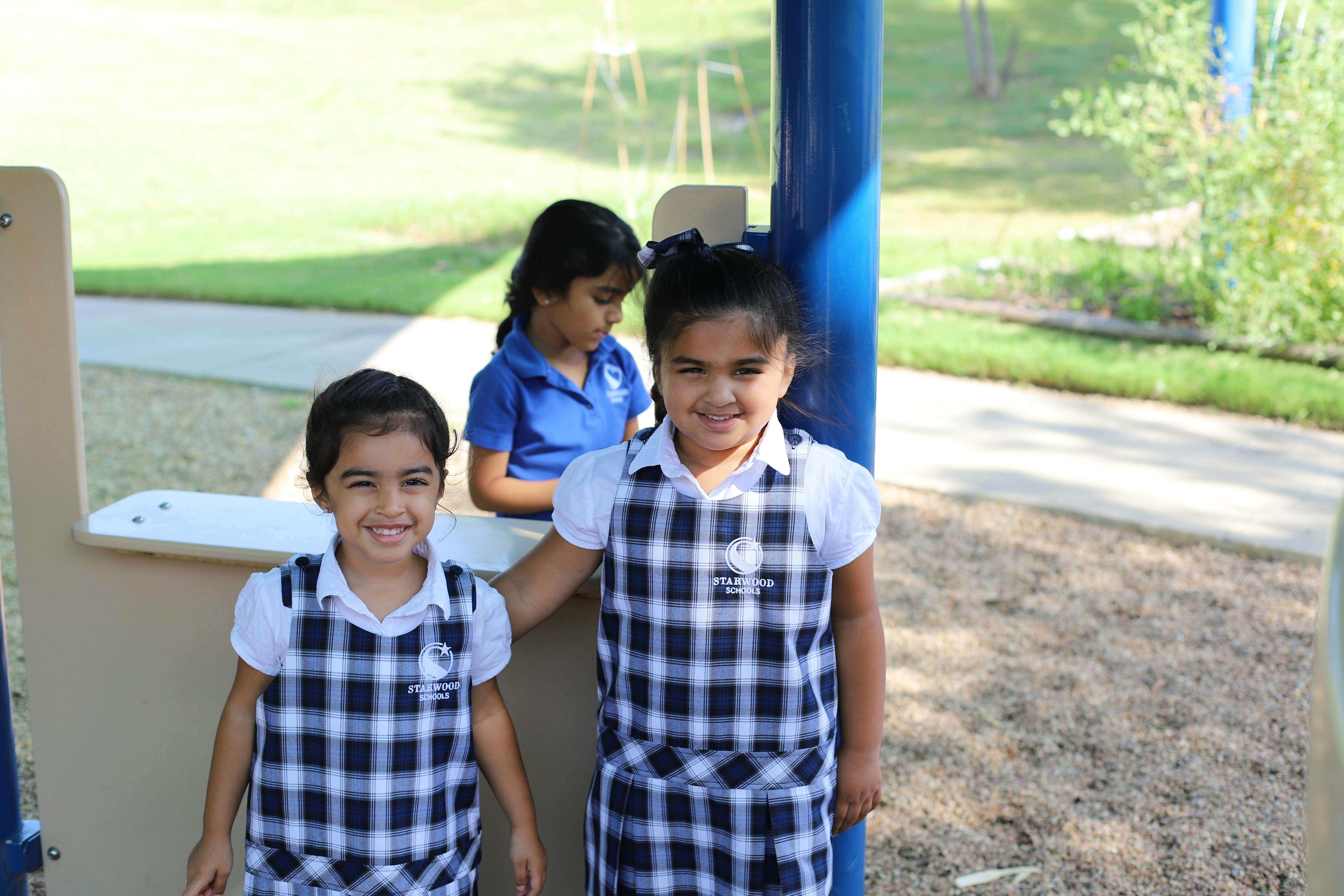 Three children on a playground structure