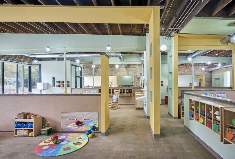 Playroom with colorful rug and toys on the floor