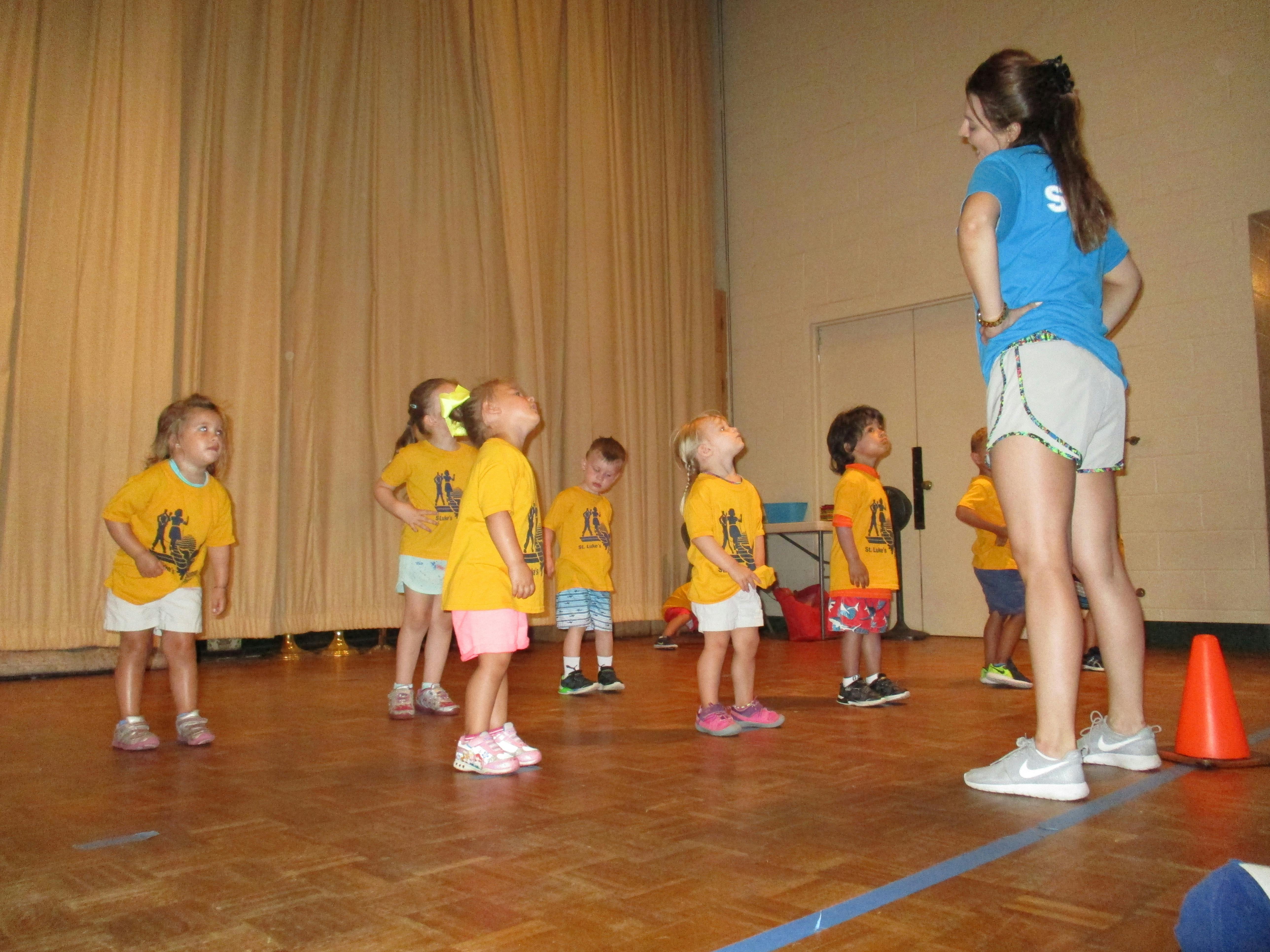 Person instructing a group of children