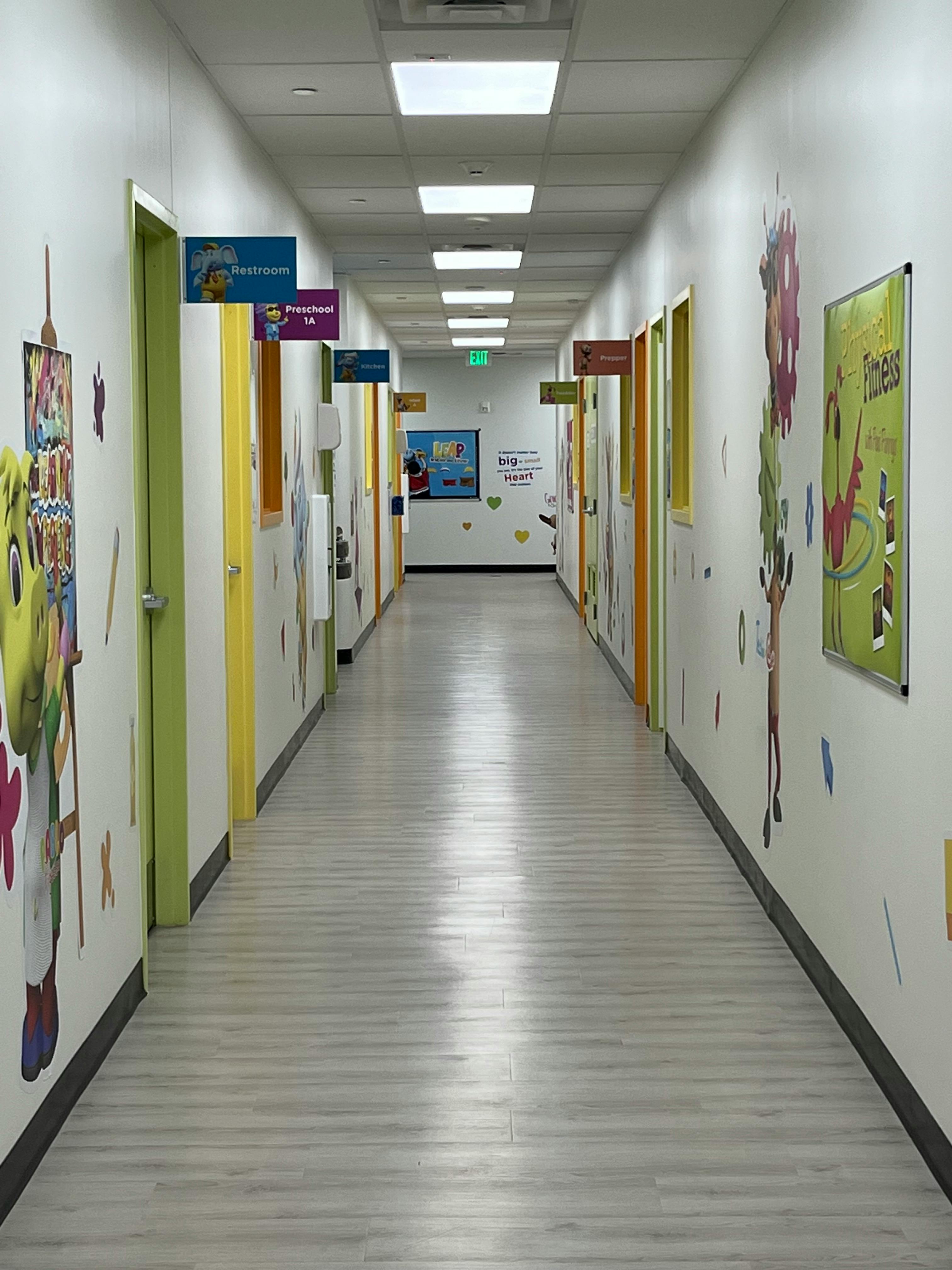 Long hallway with doors and colorful decorations on the walls
