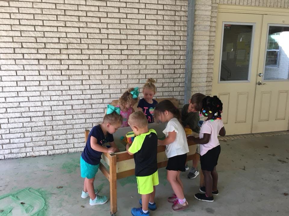 Group of children playing around a table