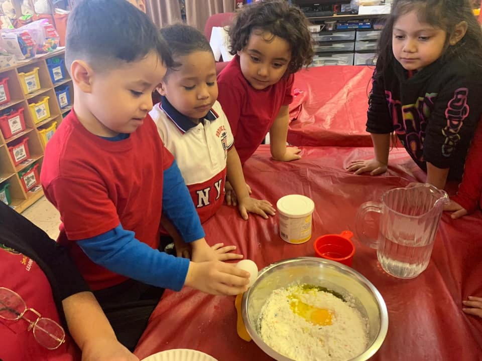 Children preparing food ingredients in a classroom