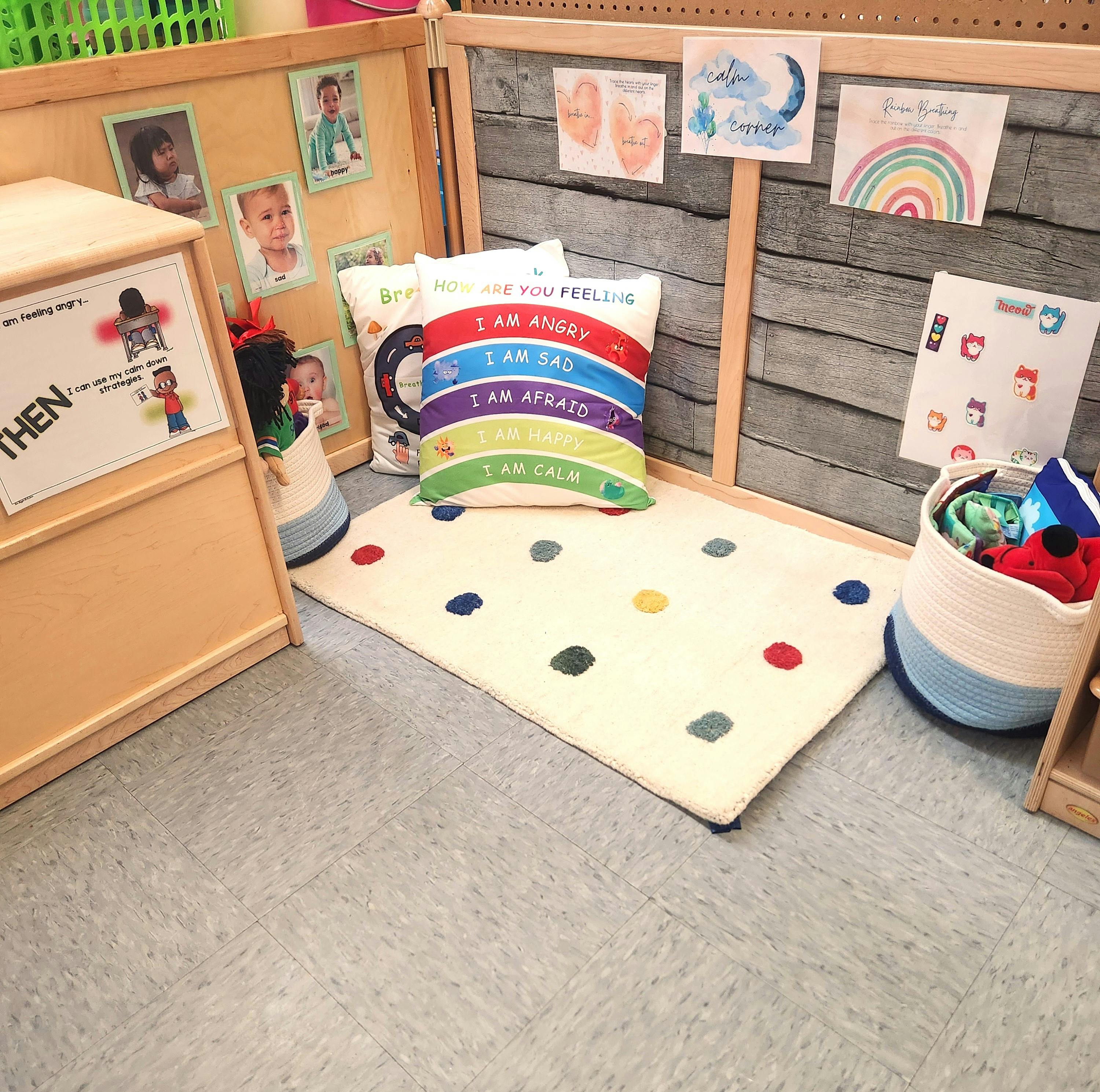 Classroom corner with a rug, pillow, and various learning materials