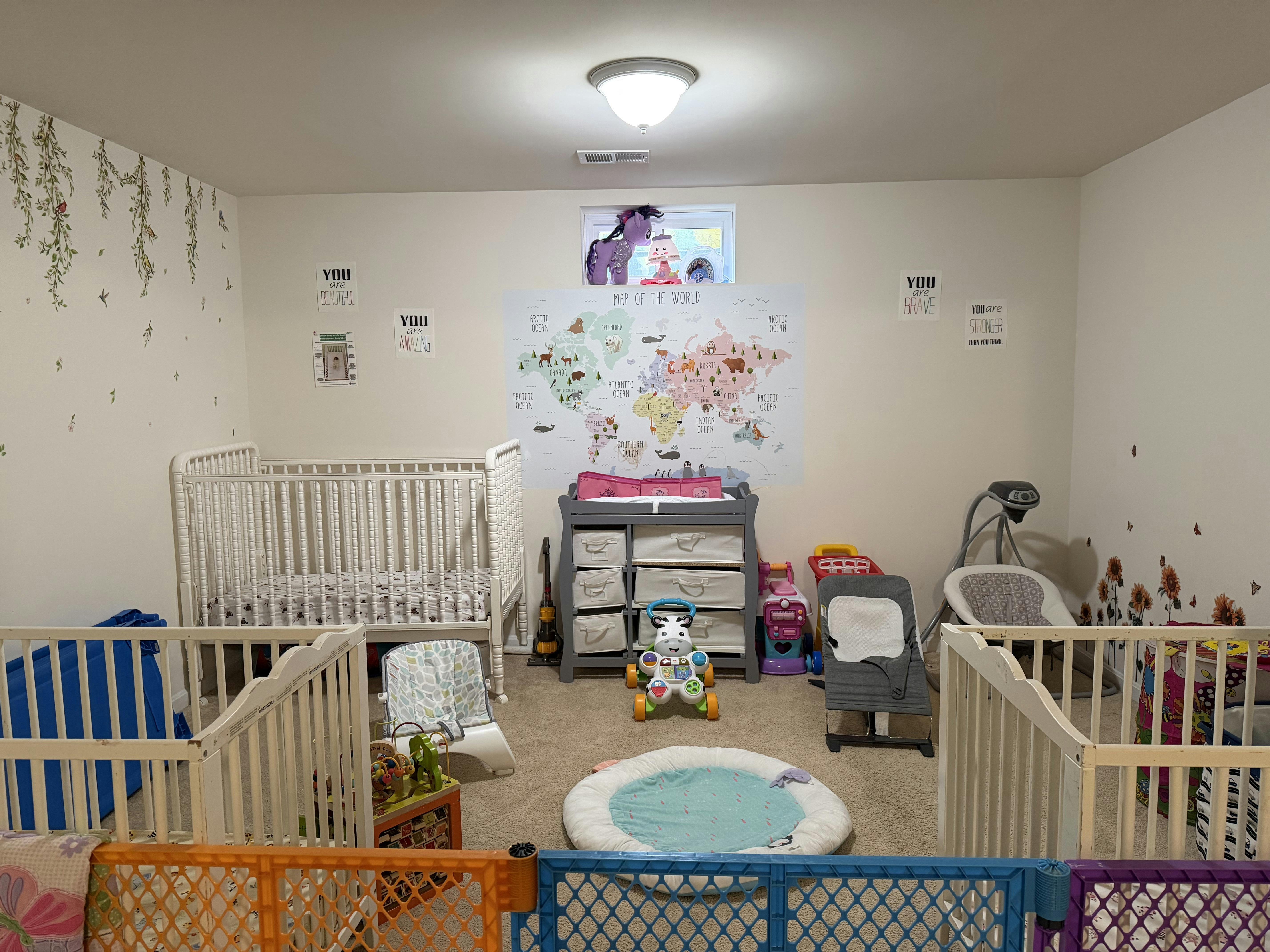 Cribs and baby gear arranged in a children's play area