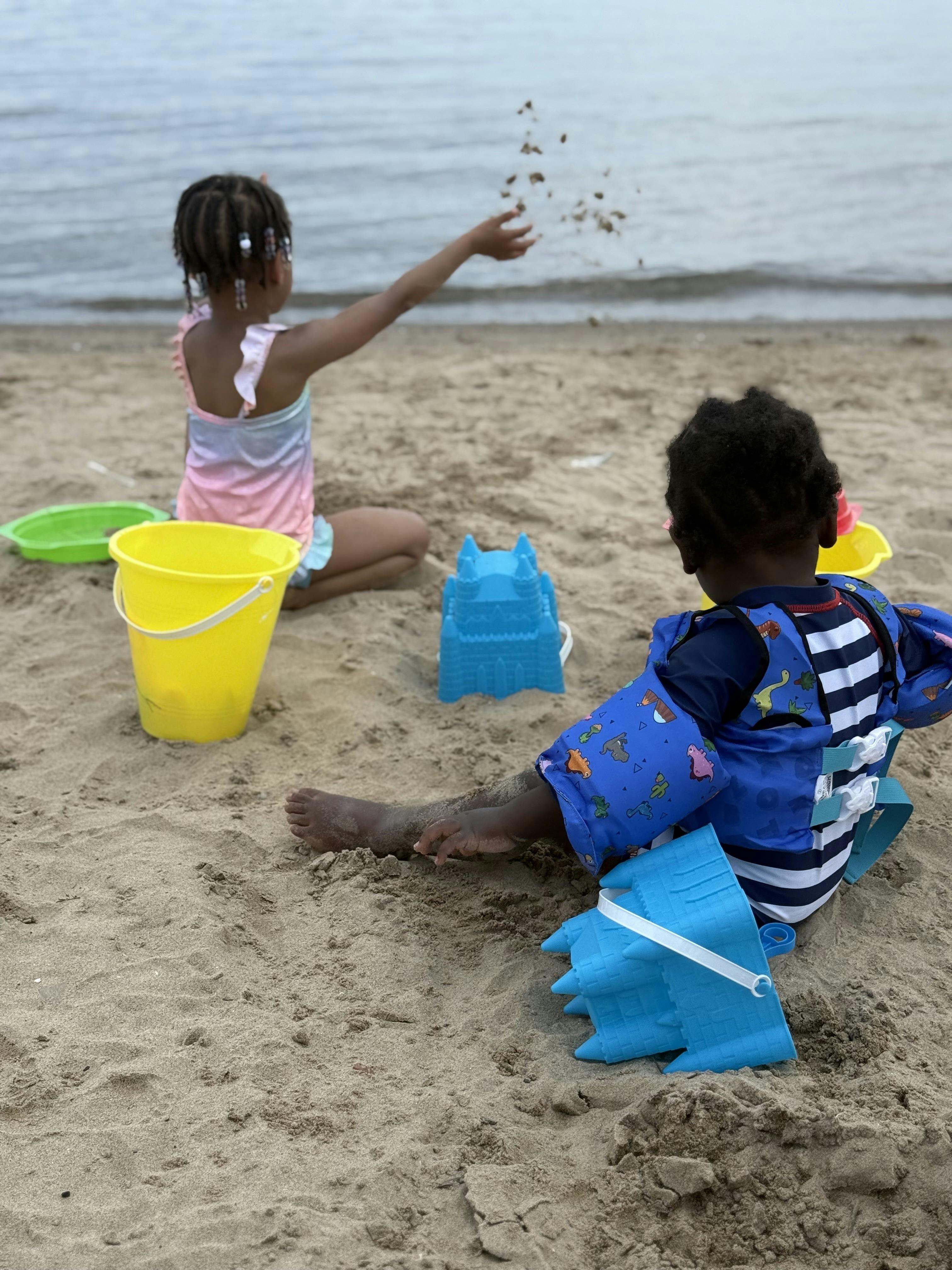 Two children playing in the sand at a beach