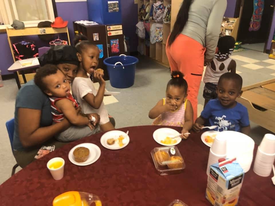 Adult and children eating at a table