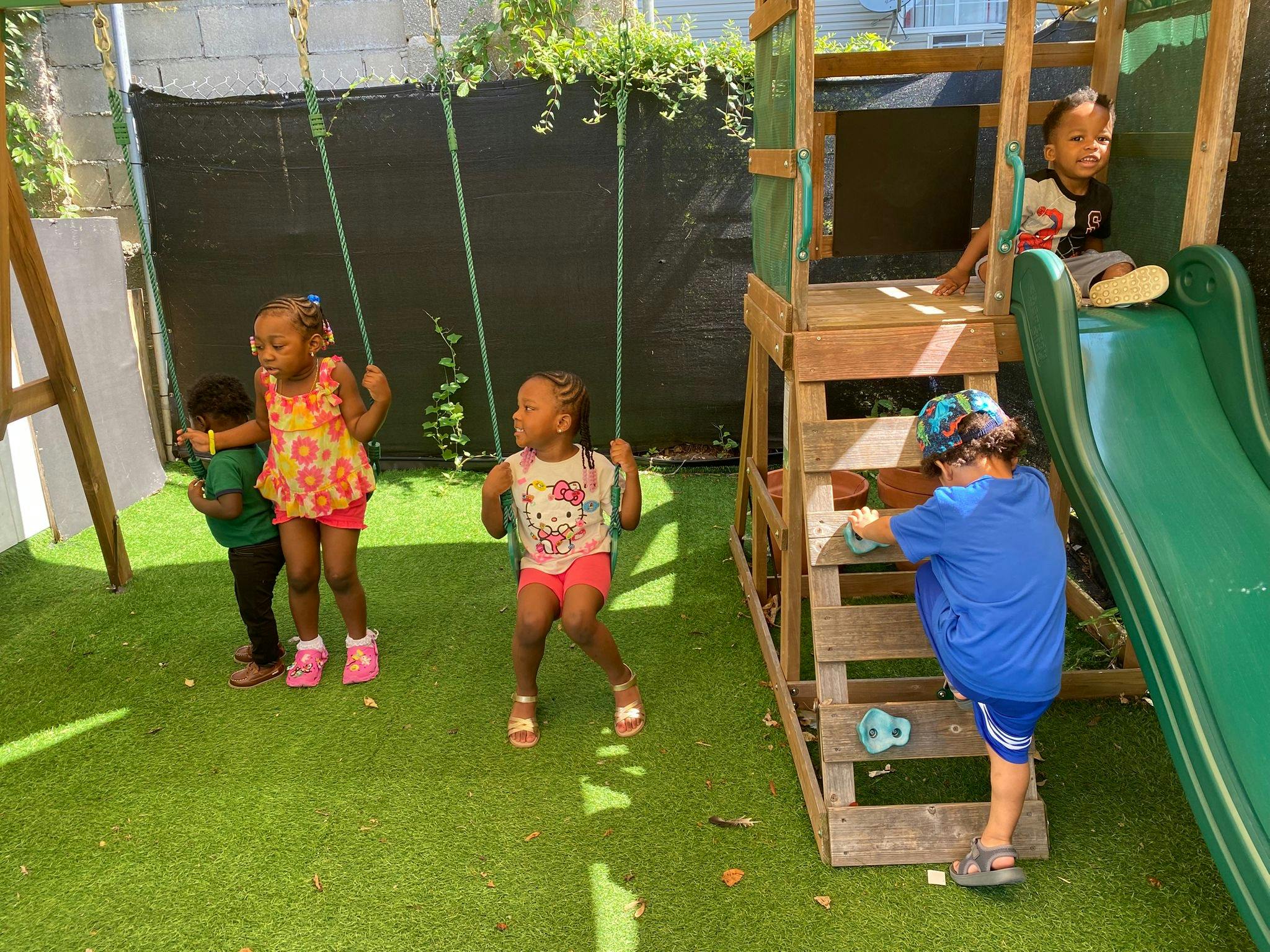 Children playing on swings and a playset