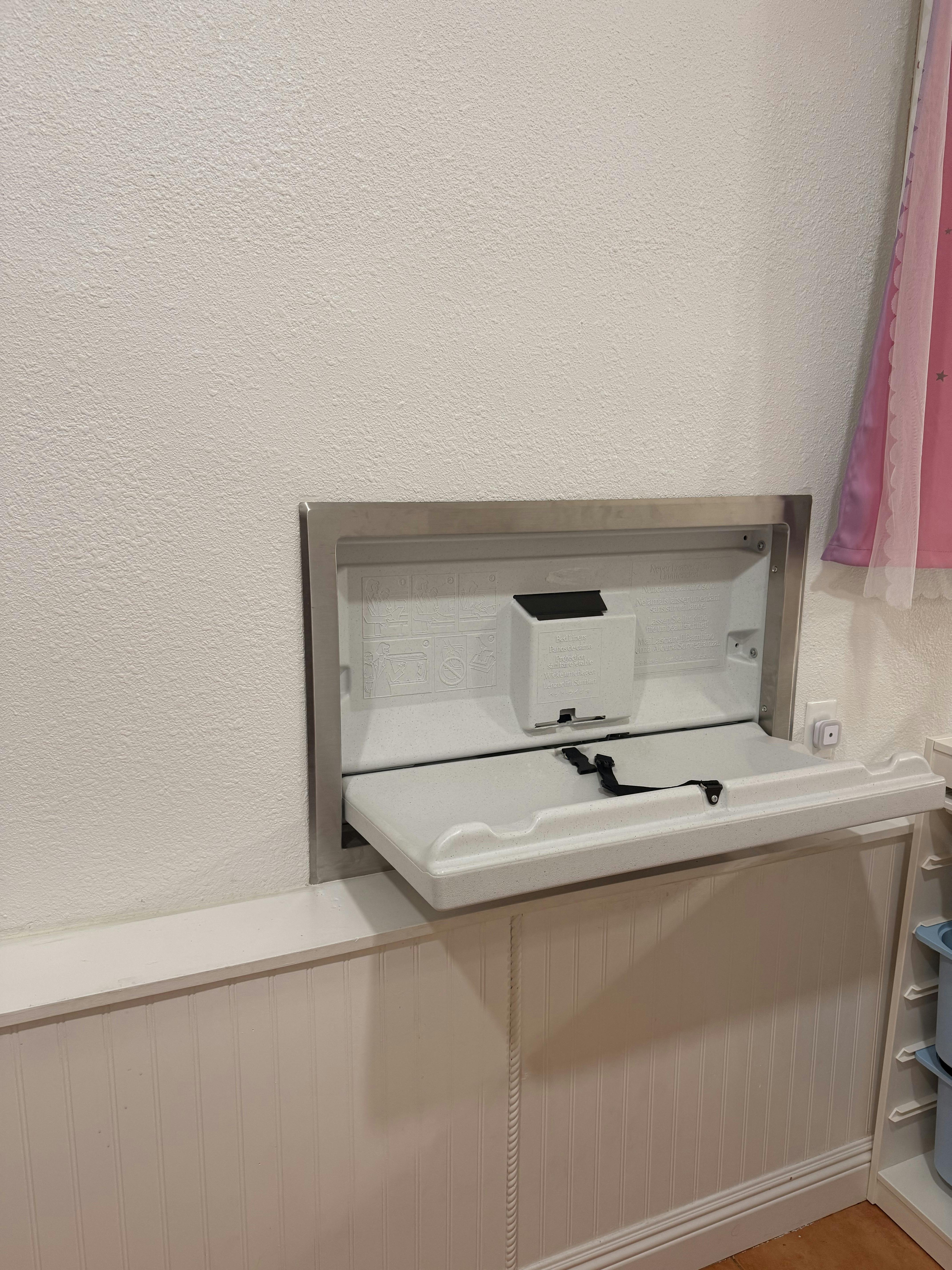 Fold-down wall-mounted diaper changing station