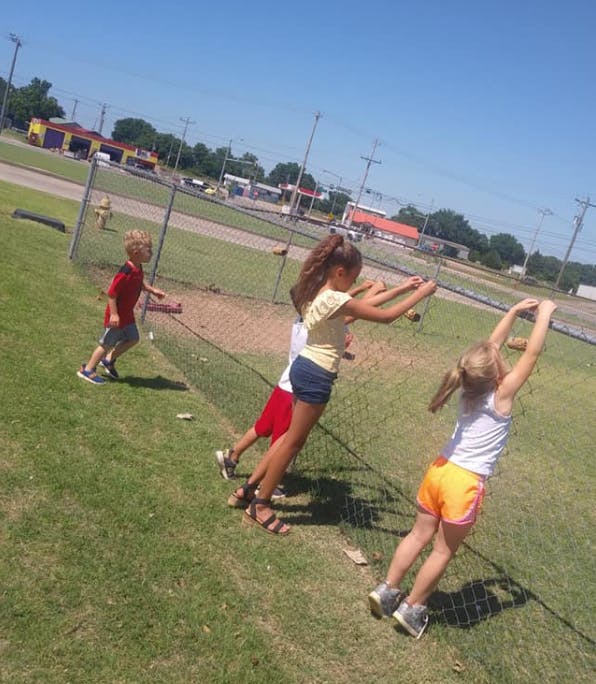 Children playing on a fence